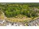 Aerial view of a park with walking paths, landscaping, trees and other amenities within a residential community at 3862 Firewood Ln # 110, Suwanee, GA 30024