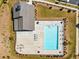 Overhead view of a pool with lounge chairs, tables, and a nearby fire pit surrounded by well-maintained landscaping at 3862 Firewood Ln # 110, Suwanee, GA 30024