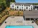 Community pool with lounge chairs, tables, and a covered area for relaxing and socializing at 3862 Firewood Ln # 110, Suwanee, GA 30024