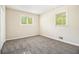 Bright bedroom featuring neutral paint, carpet flooring, and natural light from the two windows at 3995 Emerald North Dr, Decatur, GA 30035