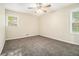 Bedroom with neutral carpet, ceiling fan, and two windows providing natural light at 3995 Emerald North Dr, Decatur, GA 30035