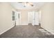 Bedroom with neutral carpet, ample closet space, and a window letting in natural light at 3995 Emerald North Dr, Decatur, GA 30035