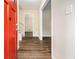 Inviting entryway featuring hardwood floors, a bright red front door, and neutral wall paint at 3995 Emerald North Dr, Decatur, GA 30035