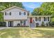 Charming two-story home with a manicured lawn, black shutters, and a vibrant red front door at 3995 Emerald North Dr, Decatur, GA 30035