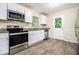 Bright kitchen features stainless steel appliances, granite countertops, and ample white cabinetry at 3995 Emerald North Dr, Decatur, GA 30035