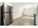 Large living room with wood-look floors, stainless steel fridge, and natural light at 3995 Emerald North Dr, Decatur, GA 30035