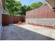 View of the home's fenced courtyard with mulched flower beds and concrete flooring at 5058 Meadow Ne Ln, Marietta, GA 30068