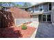 This townhouse includes a spacious courtyard with mulched flower beds and gray siding at 5058 Meadow Ne Ln, Marietta, GA 30068