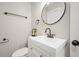 Bathroom featuring a sleek vanity with a black faucet and modern, round mirror at 5058 Meadow Ne Ln, Marietta, GA 30068