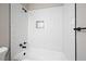 Modern bathroom featuring a shower with a tiled surround and black fixtures at 5058 Meadow Ne Ln, Marietta, GA 30068