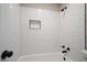 Modern bathroom featuring a shower with a tiled surround and black fixtures at 5058 Meadow Ne Ln, Marietta, GA 30068