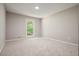 Bedroom with neutral carpet and trim, natural light, and window view of trees at 5058 Meadow Ne Ln, Marietta, GA 30068
