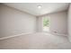 Neutral bedroom features a large window and soft carpet at 5058 Meadow Ne Ln, Marietta, GA 30068