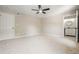 Bedroom featuring neutral carpet, ceiling fan and attached bath at 5058 Meadow Ne Ln, Marietta, GA 30068