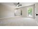 Carpeted bedroom featuring natural light and ceiling fan at 5058 Meadow Ne Ln, Marietta, GA 30068