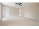 Carpeted bedroom with a ceiling fan and two entry doors at 5058 Meadow Ne Ln, Marietta, GA 30068