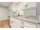 Bright and fresh kitchen includes stainless dishwasher and white cabinets at 5058 Meadow Ne Ln, Marietta, GA 30068