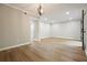 Well-lit living room with wood floors, neutral walls, and modern chandelier at 5058 Meadow Ne Ln, Marietta, GA 30068