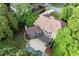 Aerial view of home with a private pool, patio, deck and mature trees at 770 Pine Leaf Ct, Alpharetta, GA 30022