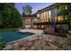 Inviting backyard showcasing a swimming pool, stone patio, and well-maintained landscaping at 770 Pine Leaf Ct, Alpharetta, GA 30022