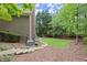 Lush backyard with stone steps leading to a well-maintained lawn and surrounding trees at 770 Pine Leaf Ct, Alpharetta, GA 30022