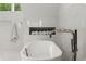 Modern white tub with silver hardware and marble tile surround at 770 Pine Leaf Ct, Alpharetta, GA 30022