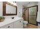 Clean bathroom with a white vanity, large mirror, and glass-enclosed shower at 770 Pine Leaf Ct, Alpharetta, GA 30022