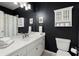 Bathroom featuring black walls, white sink and toilet at 770 Pine Leaf Ct, Alpharetta, GA 30022
