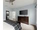 Light blue primary bedroom featuring a dresser and view to the en suite bathroom and hallway at 770 Pine Leaf Ct, Alpharetta, GA 30022