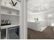 Butler pantry features a beverage fridge and shelving; the main bedroom is in the background at 770 Pine Leaf Ct, Alpharetta, GA 30022