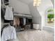 Walk-in closet features a carpet, hanging racks, storage boxes and a window at 770 Pine Leaf Ct, Alpharetta, GA 30022