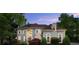 Grand home featuring well-manicured shrubbery, a dark roof, and an ornate entryway at 770 Pine Leaf Ct, Alpharetta, GA 30022