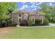 Stunning two-story home featuring arched windows, elegant landscaping, and a spacious front lawn at 770 Pine Leaf Ct, Alpharetta, GA 30022