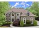 Elegant two-story home with a manicured lawn and mature landscaping at 770 Pine Leaf Ct, Alpharetta, GA 30022