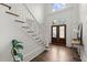 Bright foyer features hardwood floors, a staircase, and a decorative front door at 770 Pine Leaf Ct, Alpharetta, GA 30022