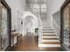 Grand foyer with staircase, hardwood floors, and soaring ceilings creates an impressive entrance at 770 Pine Leaf Ct, Alpharetta, GA 30022