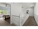 Bright hallway featuring white railings and trim, with a view into a bedroom with natural light at 770 Pine Leaf Ct, Alpharetta, GA 30022