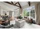 Open concept living room and kitchen area with hardwood floors, a stone fireplace, and large windows at 770 Pine Leaf Ct, Alpharetta, GA 30022