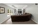 Cozy living room with a large brown leather couch, media center, and large window at 770 Pine Leaf Ct, Alpharetta, GA 30022