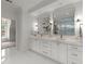 Elegant main bathroom with double vanities, marble countertops, and stylish fixtures at 770 Pine Leaf Ct, Alpharetta, GA 30022