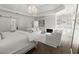 Bright main bedroom with a seating area, fireplace, and a barn door entrance to another room at 770 Pine Leaf Ct, Alpharetta, GA 30022