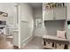 A modern mud room with a built-in bench, storage cabinets, and gray wainscoting at 770 Pine Leaf Ct, Alpharetta, GA 30022