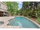 Stunning backyard pool featuring a spa, fireplace, and spacious patio area, perfect for outdoor living at 770 Pine Leaf Ct, Alpharetta, GA 30022