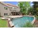 Beautiful backyard pool with a spa, outdoor fireplace, and spacious deck for entertaining at 770 Pine Leaf Ct, Alpharetta, GA 30022