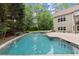 Backyard pool, patio, and lush landscaping create a private oasis with room to relax and entertain at 770 Pine Leaf Ct, Alpharetta, GA 30022