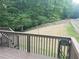 View from the deck of the grassy backyard with a wooden fence and mature trees surrounding the property at 101 Brendylynn Trce, Woodstock, GA 30188