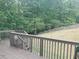 View from the deck of the grassy backyard with a wooden fence and mature trees surrounding the property at 101 Brendylynn Trce, Woodstock, GA 30188