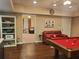 Finished basement area featuring a pool table, red leather couch, and kitchenette at 101 Brendylynn Trce, Woodstock, GA 30188