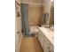 Well-lit bathroom featuring a tiled shower and double sinks at 101 Brendylynn Trce, Woodstock, GA 30188