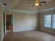 Spacious bedroom featuring a tray ceiling, ceiling fan, and light-filled windows at 101 Brendylynn Trce, Woodstock, GA 30188
